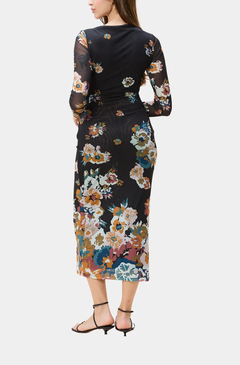 Woman wearing a black floral dress on a white background