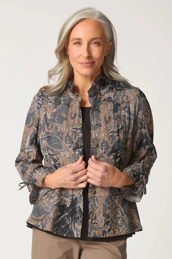Woman wearing a patterned jacket on a white background