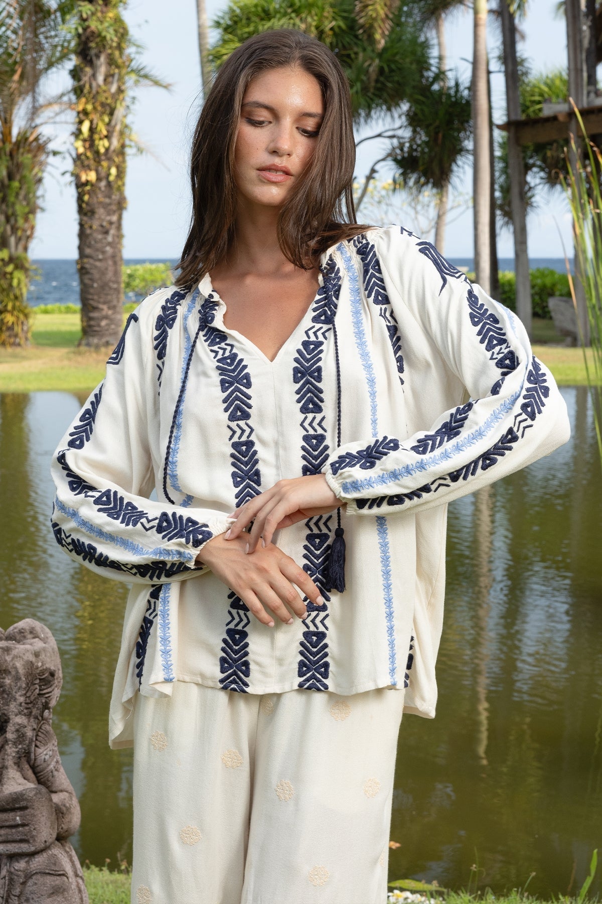 Ecru Flore Blouse by MISS JUNE, lightweight tops with a relaxed fit and delicate fabric, displayed on a hanger.
