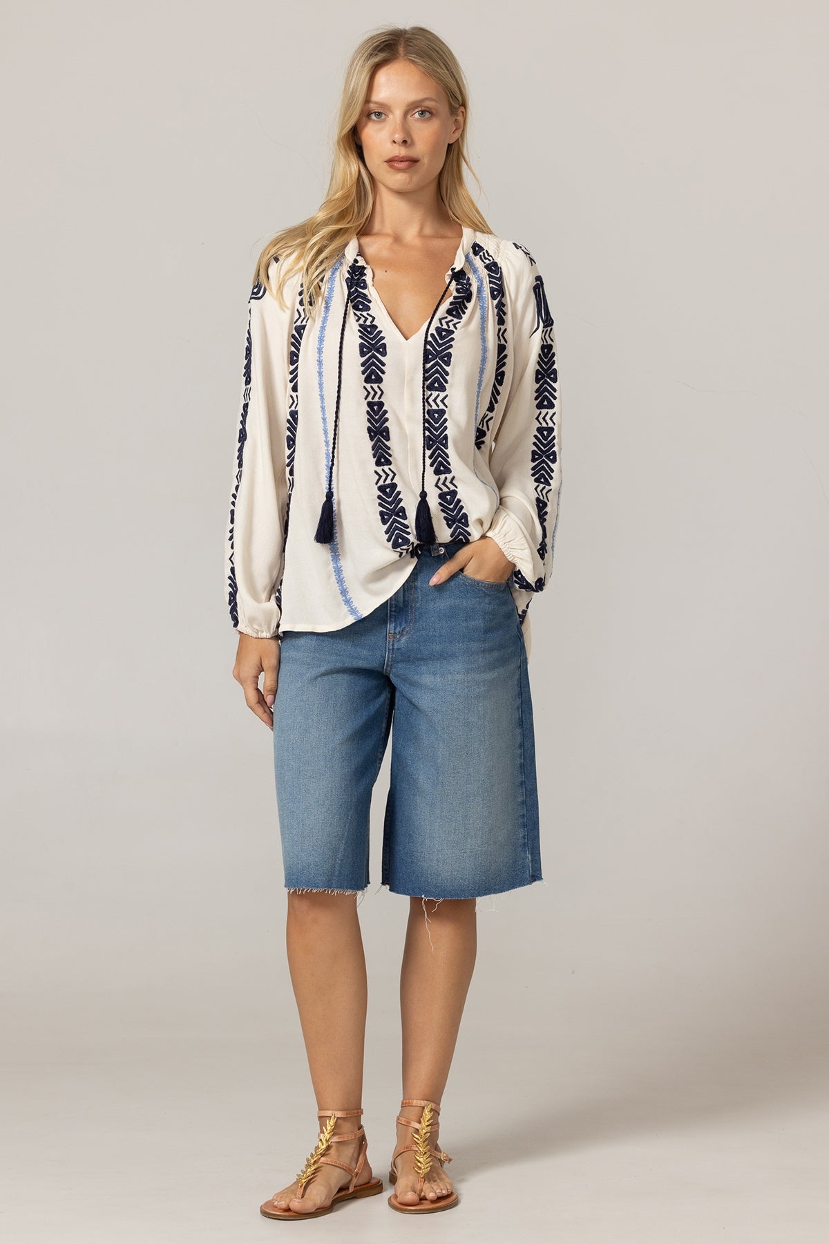 Ecru Flore Blouse by MISS JUNE, lightweight top featuring delicate fabric and subtle detailing, displayed on a hanger.