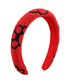 Red headband with black paw patterns on a white background