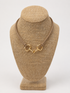 A gold horsebit-style clasp tan rope necklace 