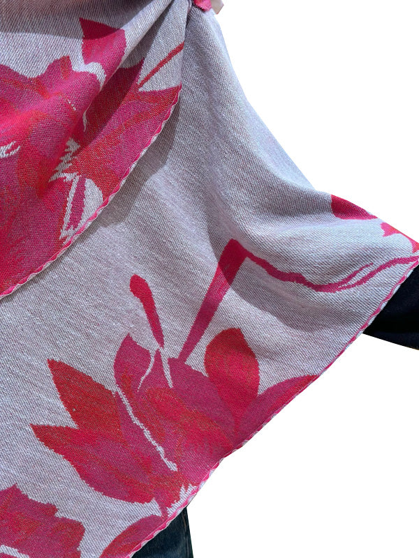 Close-up of a gray scarf with pink floral patterns