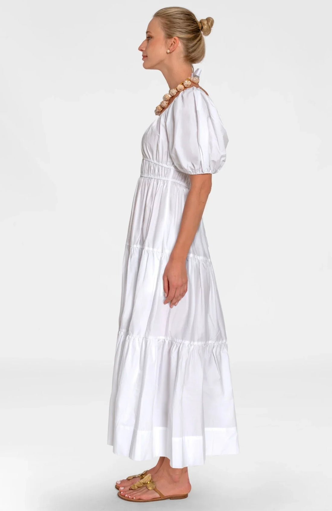 Woman wearing a white dress on a white background