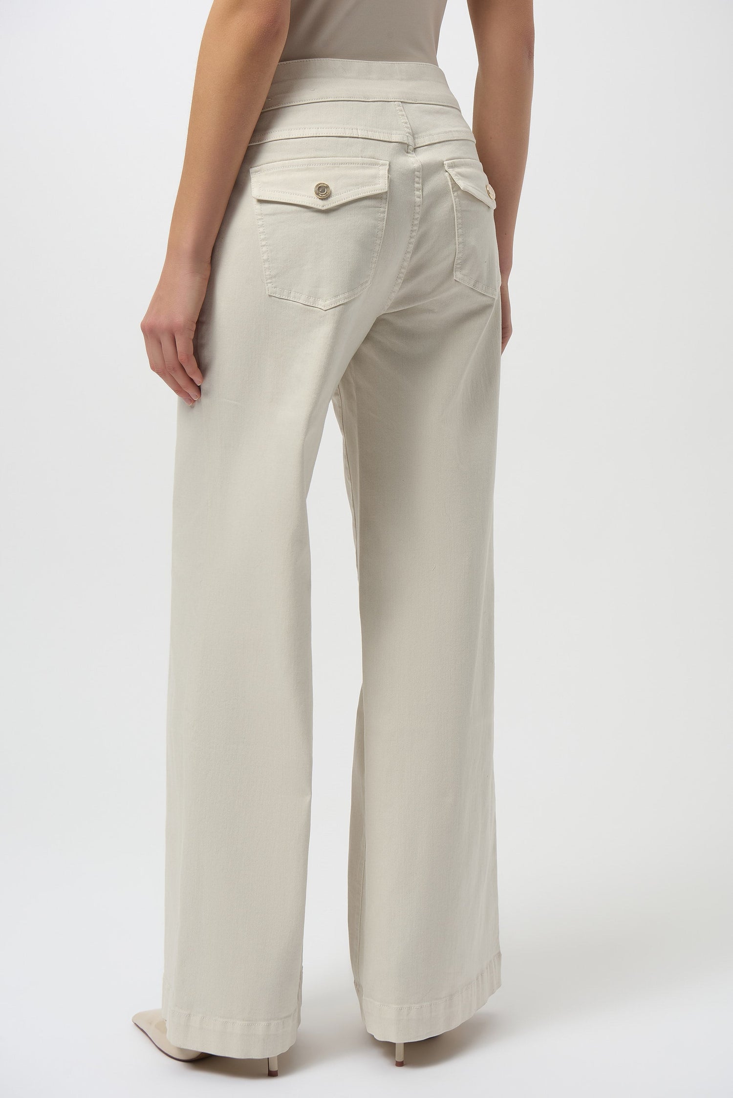 Beige wide-leg pants worn by a person on a white background
