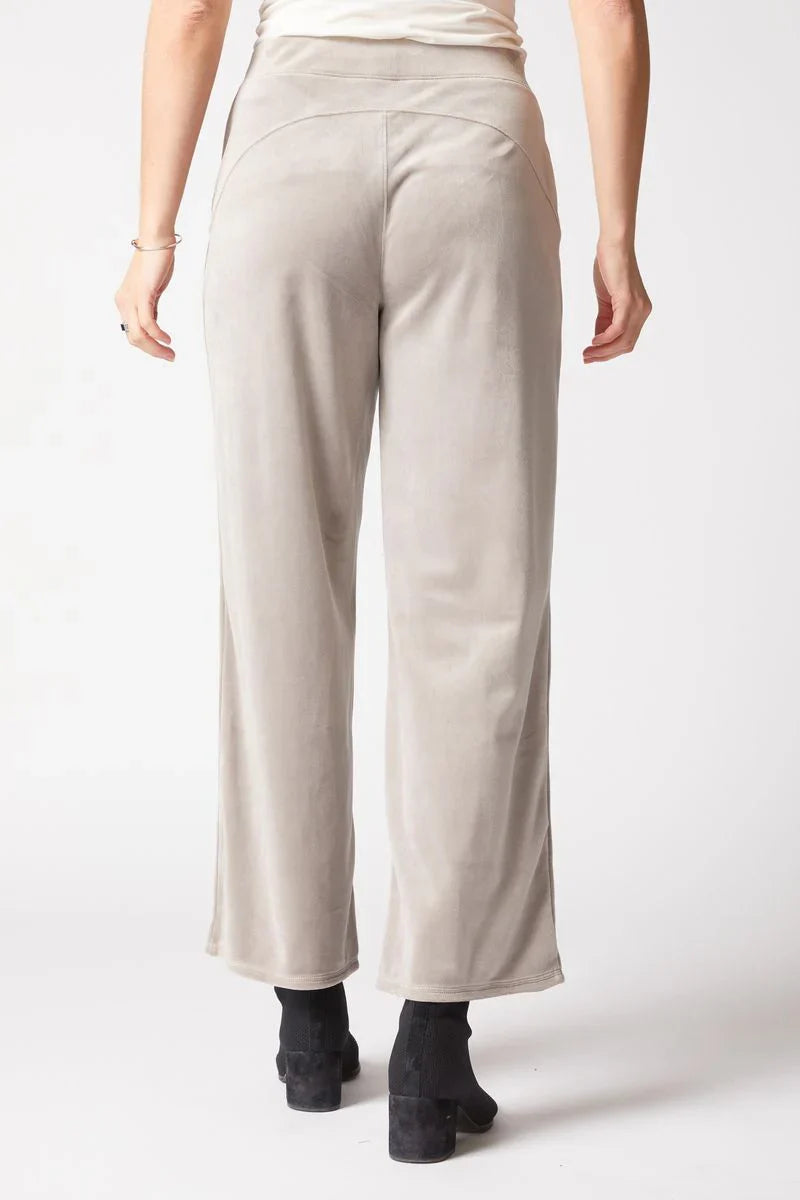 Beige pants worn by a person on a white background
