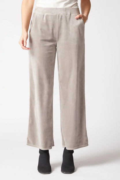 Beige pants worn by a person on a white background