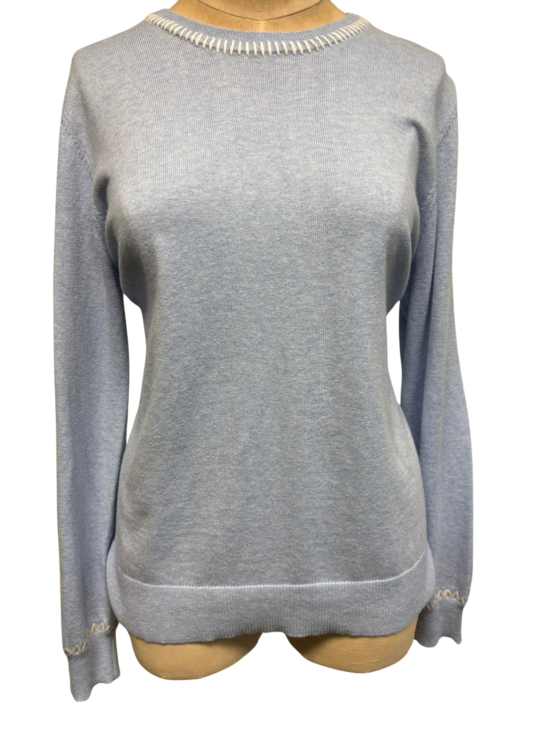 Light blue sweater with white stiching on a mannequin with a white background