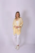Woman wearing a light yellow Ari Bamboo Shawl Wrap 