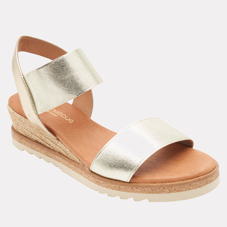 André Assous Neveah metallic wedge shoes with platform sole and ankle straps, in shiny platinum finish.