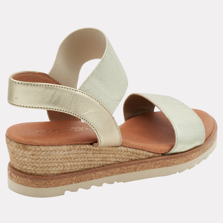 Andre Assous Neveah Metallic Wedge Shoes in platinum with open toe and ankle strap, stylish footwear for casual or dressy occasions.