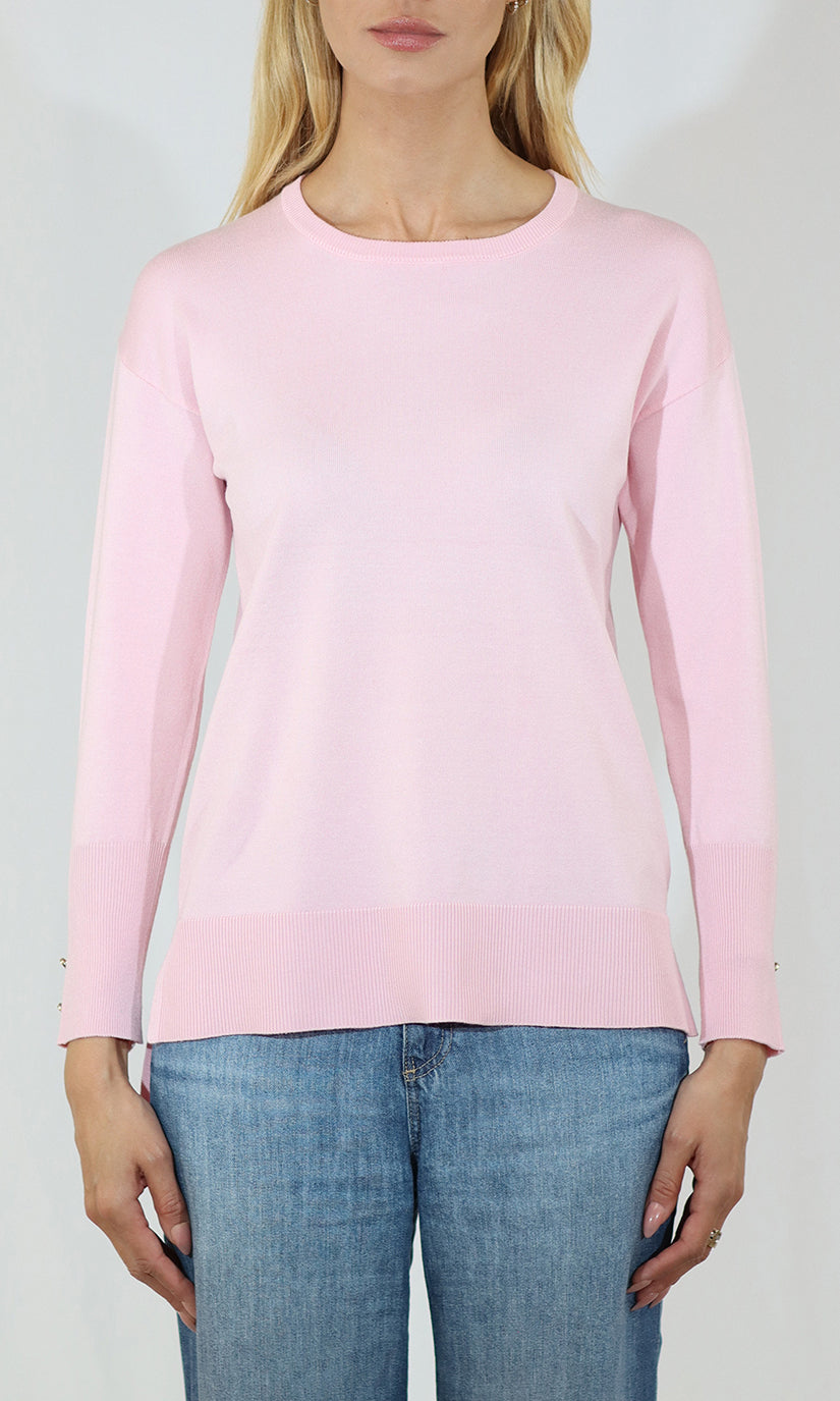 Person wearing a pink long-sleeve top and blue jeans on a white background