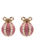 Pink glittery christmas earrings with pearl accents and gold bows on a white background