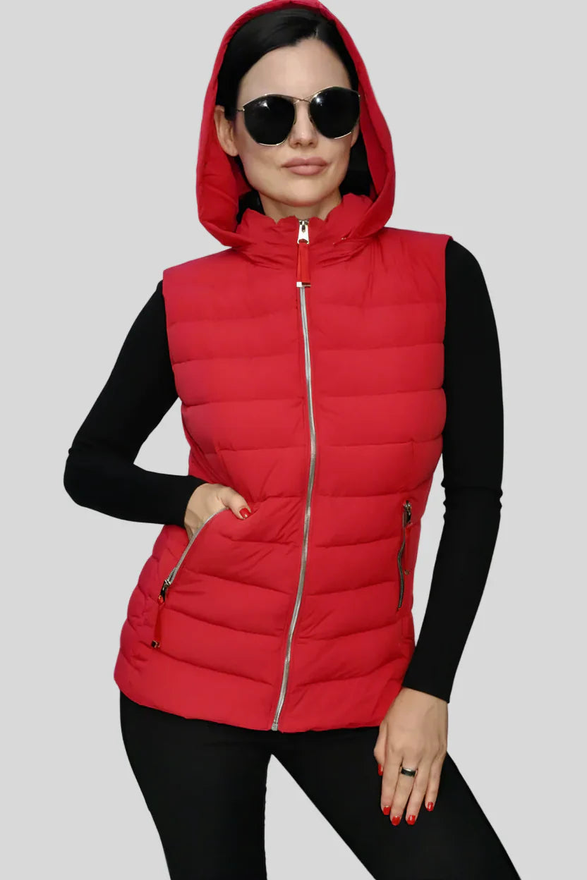 Woman wearing a red puffer vest on a gray background