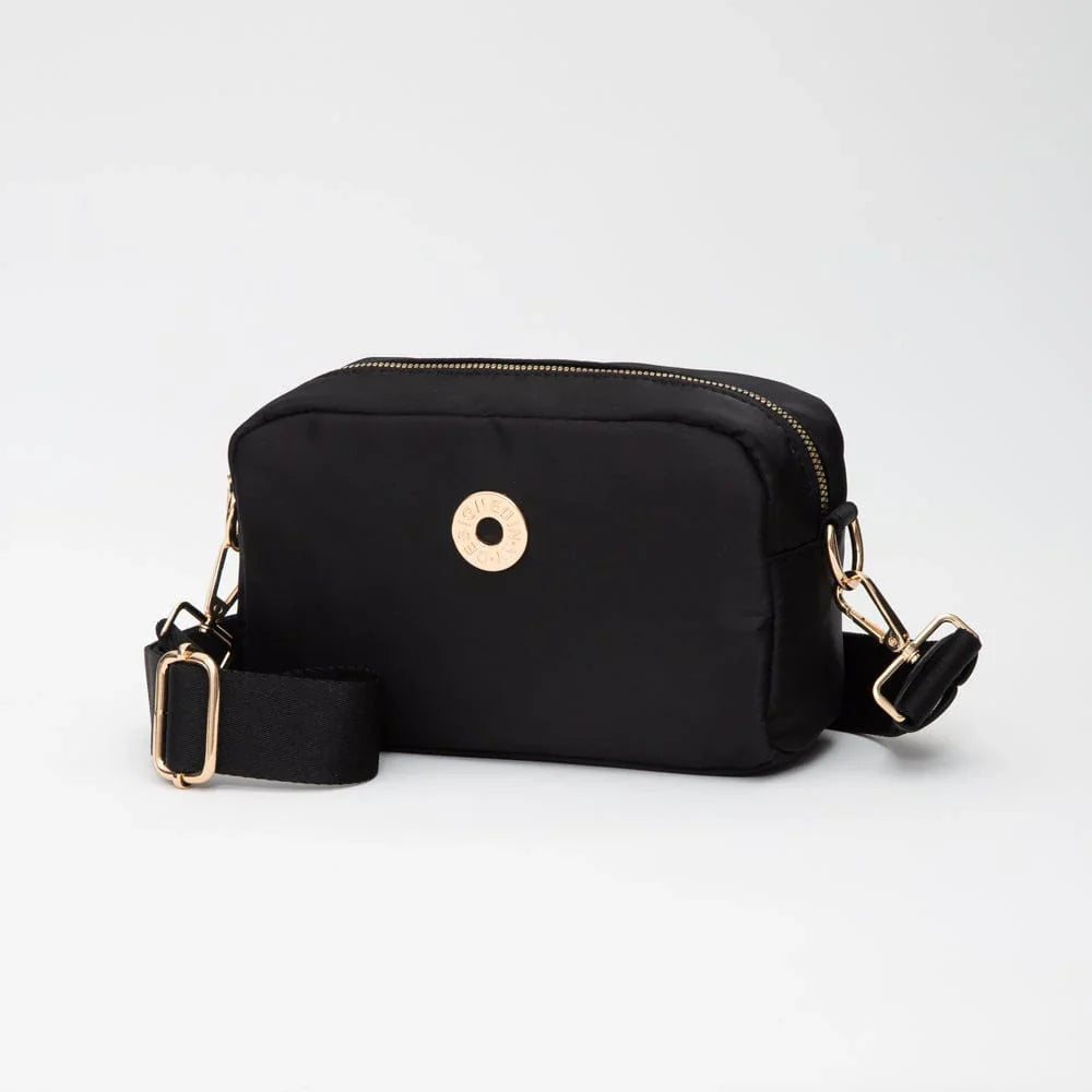 Black crossbody bag with gold accents on a white background