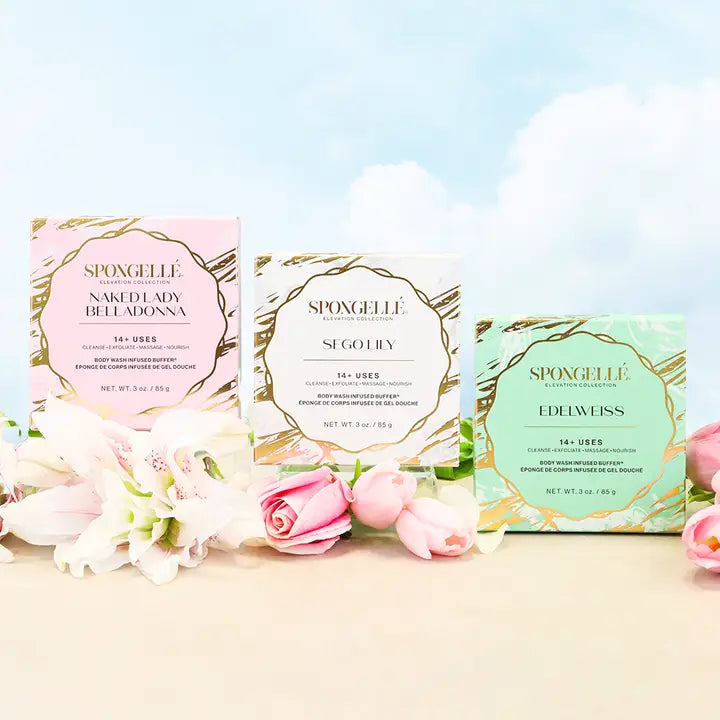 Three Elevation body buffers Spongelle product boxes with floral arrangements on a light background