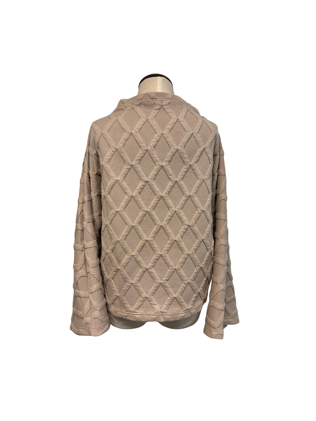 Beige quilted jacket on a mannequin against a white background
