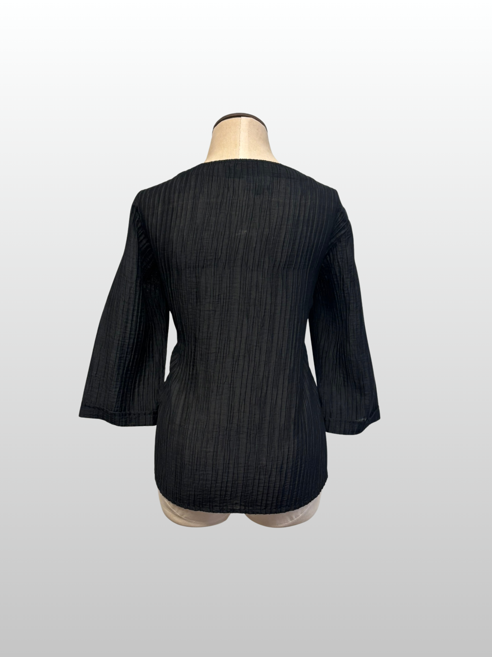 Black textured jacket on a mannequin against a white background