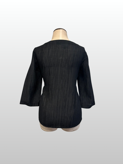 Black textured jacket on a mannequin against a white background