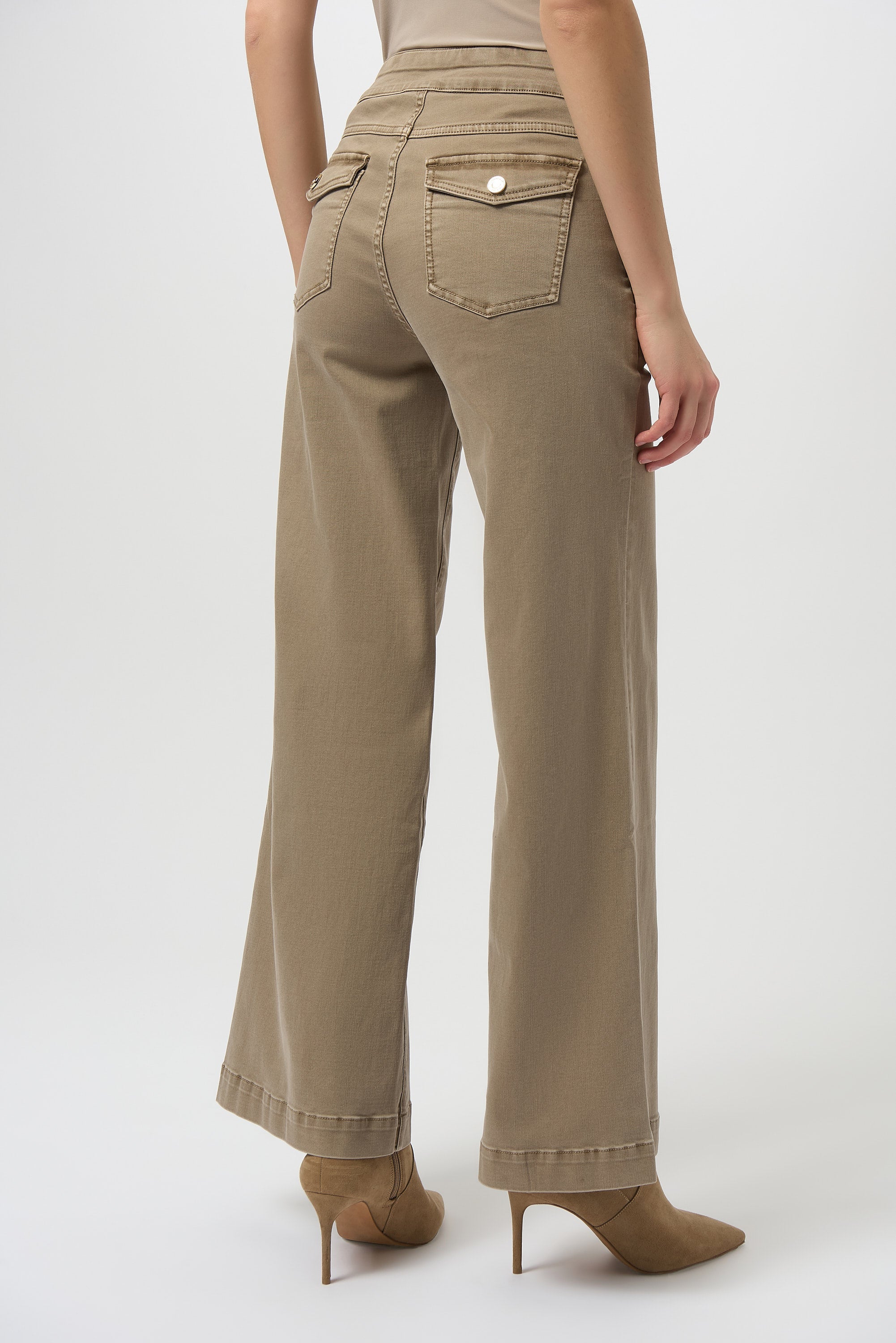 Beige pants worn by a person on a white background