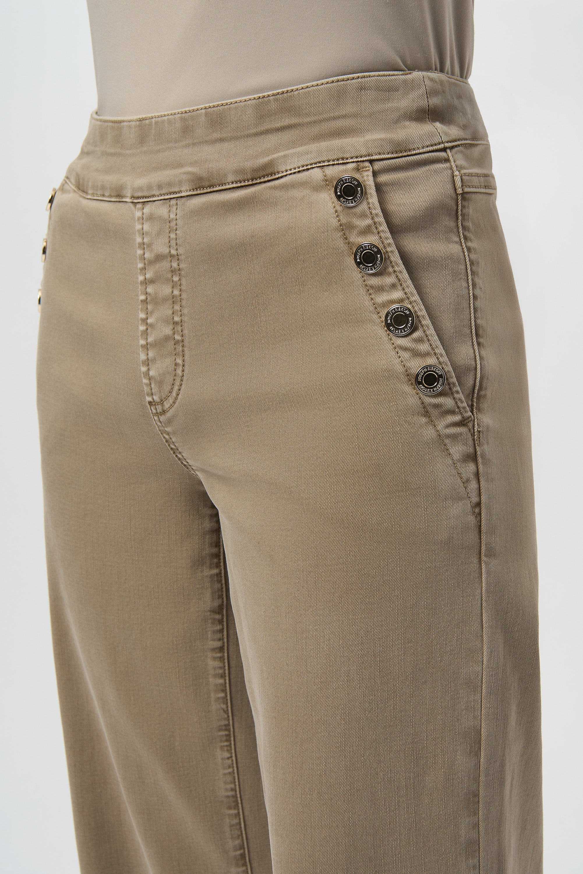 Beige pants with button details on a white background