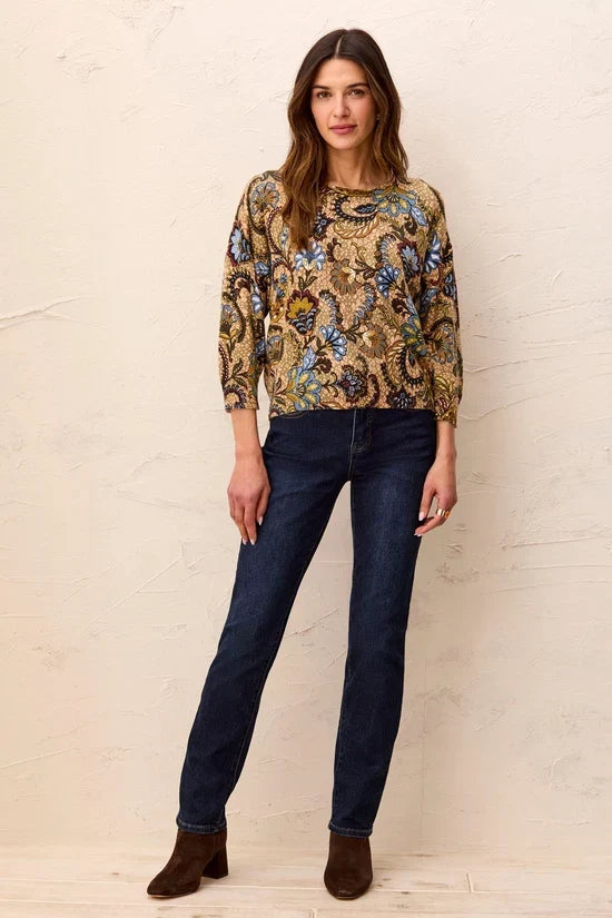 A woman wearing a long-sleeve crewneck top with an intricate paisley and floral pattern in gold, blue, green, and brown by tribal Soft Yarn Three-Quarter Sleeve Crewneck Sweater