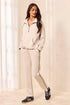 A woman modeling a matching beige tracksuit with a half-zip pullover and straight-leg pants, featuring thin black side stripes by tribal TECHNO LUX Pop Over Quarter Zip Pullover