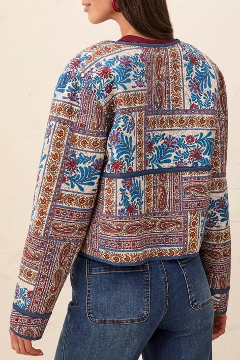 tribal Sharp Reversible Quilt Jacket quilted jacket with a vibrant multicolor paisley and floral pattern in blue, red, and gold.