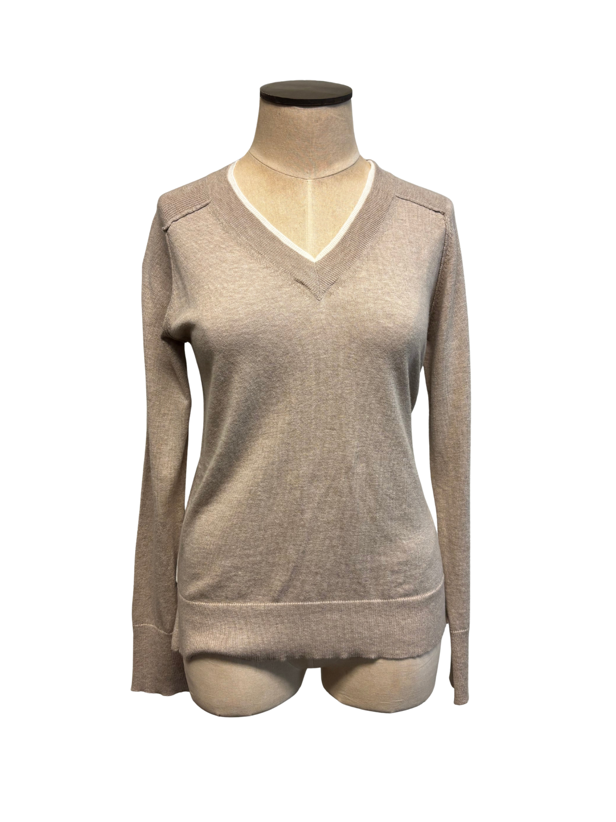 Beige sweater on a mannequin against a white background