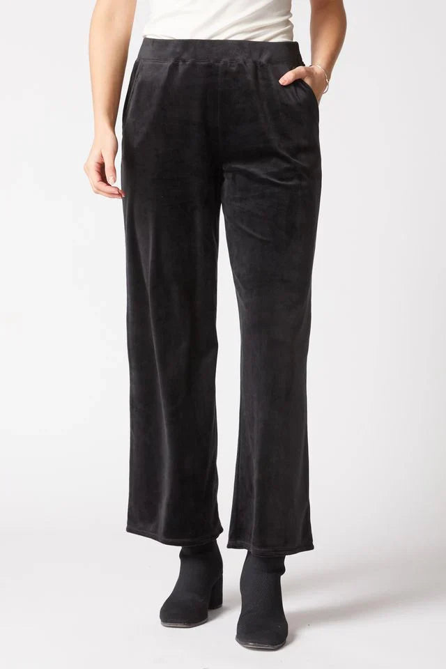 Person wearing black pants on a white background