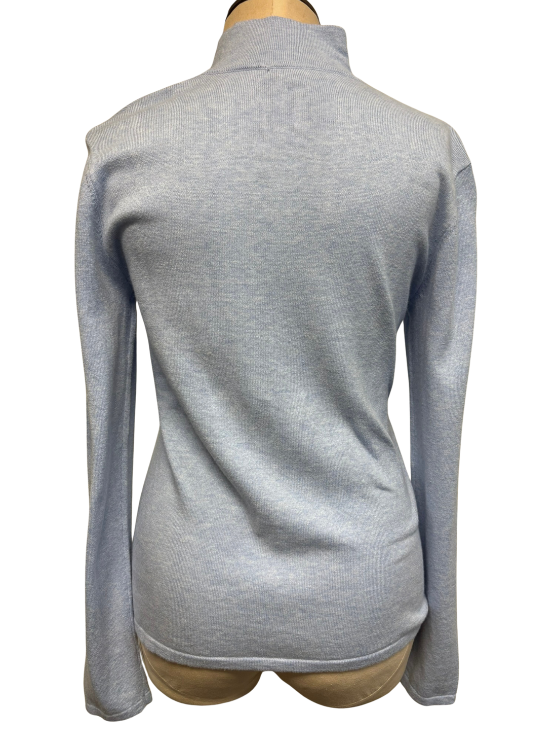 The back of a light sky blue zip-up cardigan on a mannequin against a white background