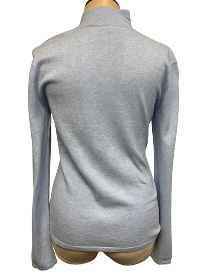 The back of a light sky blue zip-up cardigan on a mannequin against a white background
